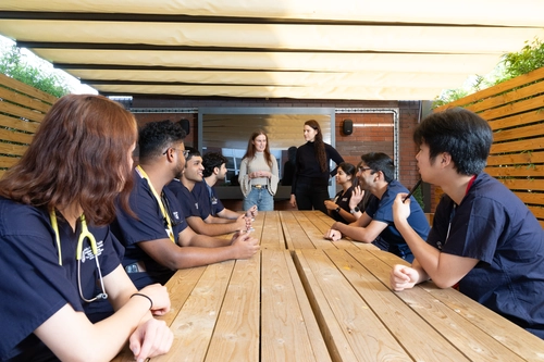 students getting lectured in an outdoor classroom