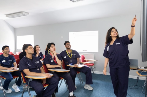students getting lectured in a room