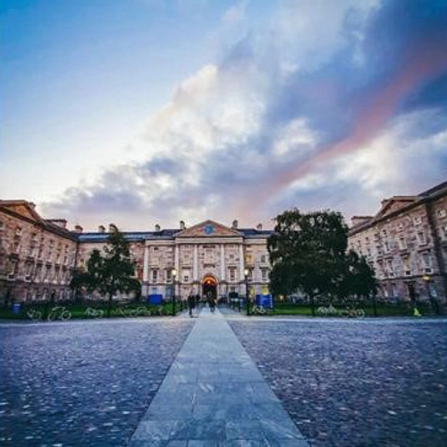Trinity front square in the morning - pink and blue sky - view from the path all the way to gate