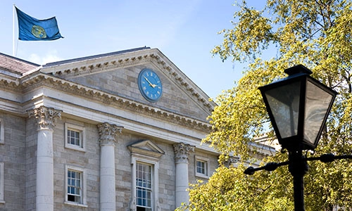View of Front Square of Trinity with flag, tree and lamppost