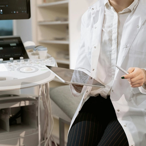 Medical professional with clipboard in clinical setting
