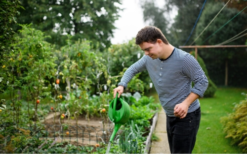 Young man with intellectual disability in the garden