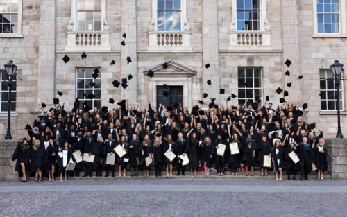 Students throw graduation caps in the air