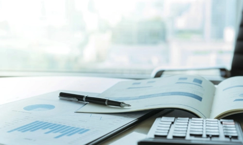 Reports lying on table and keyboard