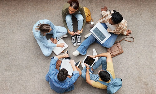 Study, laptop and group of students on floor in project, research or planning, brainstorming and teamwork. Notebook, education and top of university student, friends or people collaboration in school