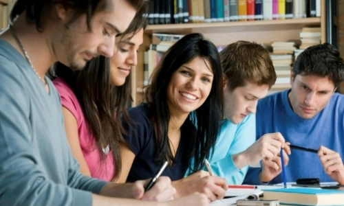 Five students working on a project together
