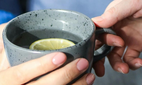closeup of hands holding a cup