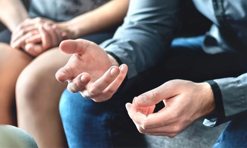 the hands of people sitting together
