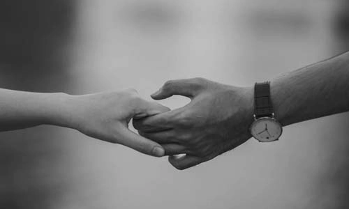 Black and white image. holding hands