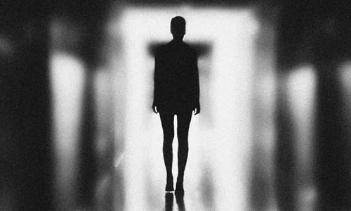 Person walking down a long corridor alone