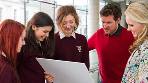 An image of transition year students with a tutor from Trinity College Dublin