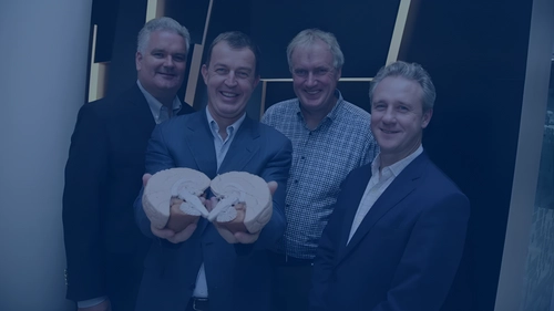 Group of men in a press shoot for the launch of a Trinity campus company