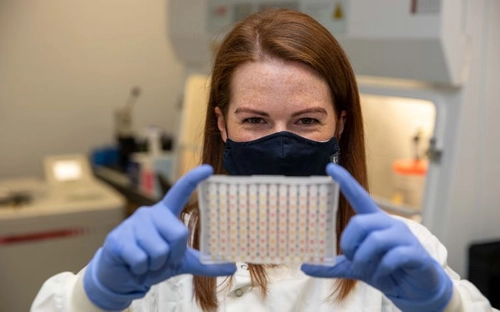 Girl holding up a lab sample