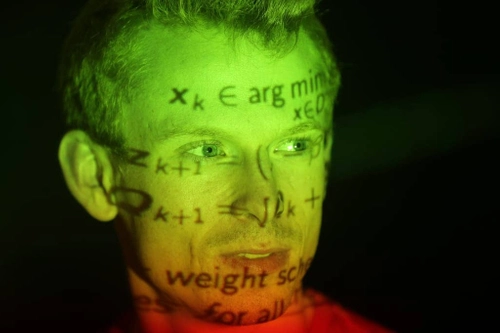 Person's face with equations light projected onto it