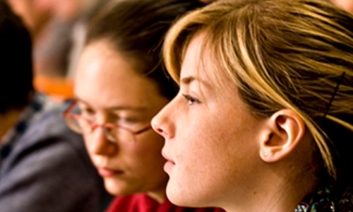 close up of 2 female students looking into the distance
