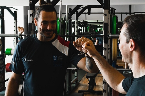 Trinity Sport personal trainer giving a client a fist bump