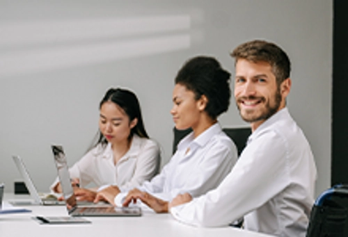 Students sitting around a laptop