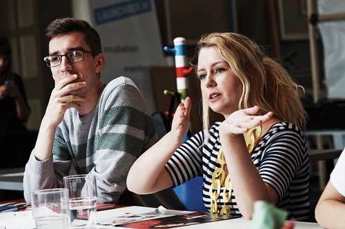 Two students interacting with a tutor at a seminar