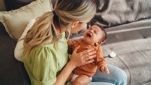 Mother holding newborn in ward