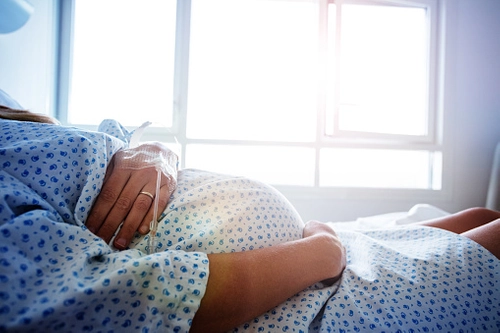 Pregnant woman in hospital bed