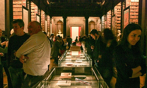 people looking at manuscripts in the old library Trinity college dublin