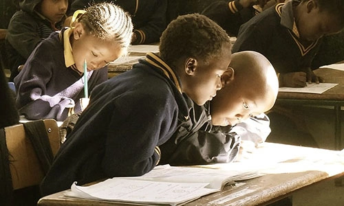 children in a classroom reading books