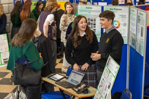 Students beside a poster