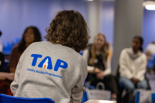 A student wearing a TAP sweatshirt