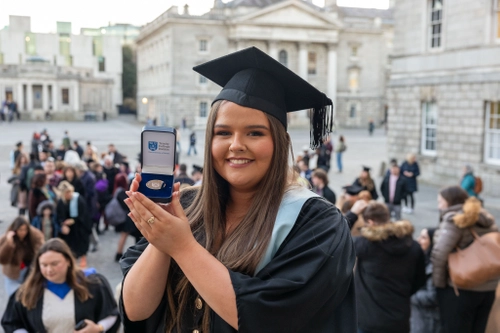 Student smiling at graduation with medal