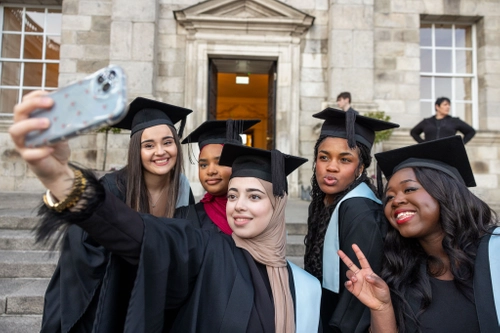 Young women take selfie at FC graduation