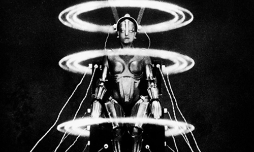 Image showing a robot that looks like a silver metal woman surrounded by big white neon circles suspending the robot in space.