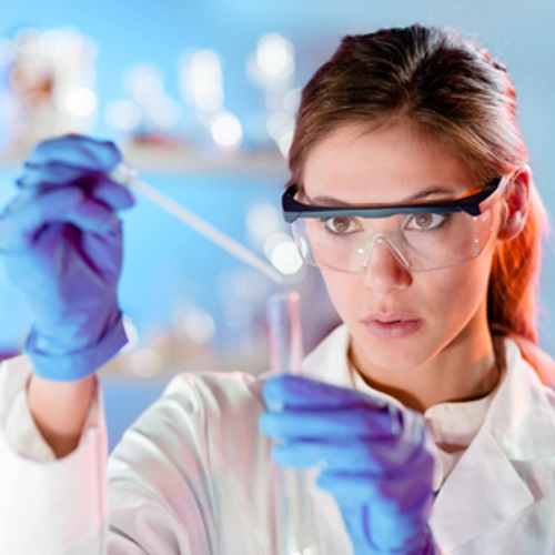lab woman putting something from a pipette into test tube