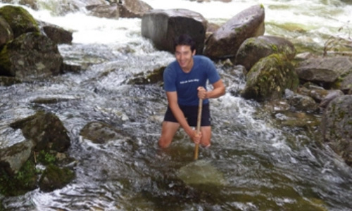 Dr. Jeremy Piggott in a river - Ecologist wins international award for research
