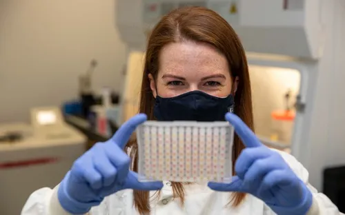 Girl holding up a lab sample
