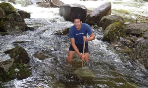 Dr. Jeremy Piggott in a river - Ecologist wins international award for research
