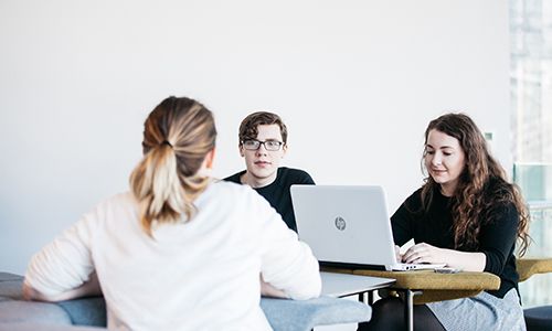 Three students on laptops