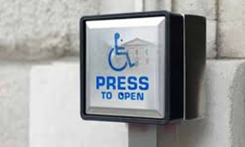 Press to open sign on a wheelchair access door push