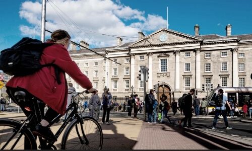 A person cycling in the direction of Trinity