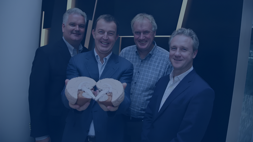 Group of men in a press shoot for the launch of a Trinity campus company