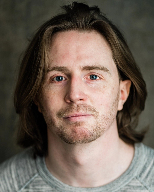 Student with shoulder length brown hair, looking at the camera.