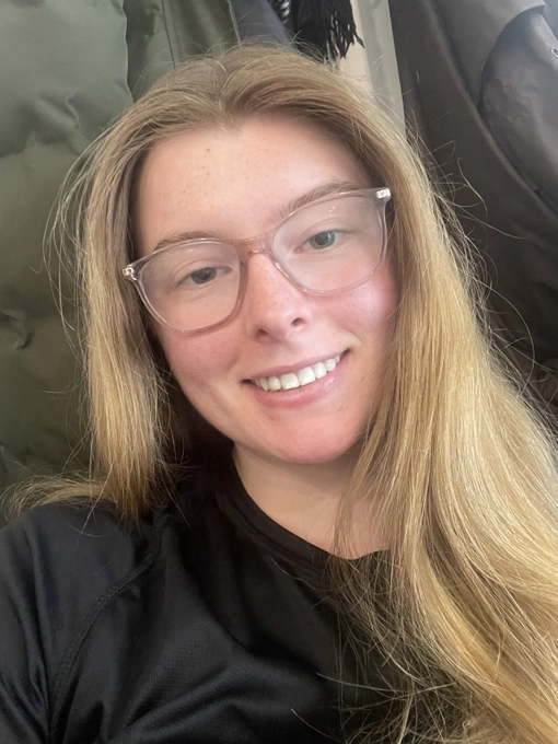 Student with long light coloured hair and glasses