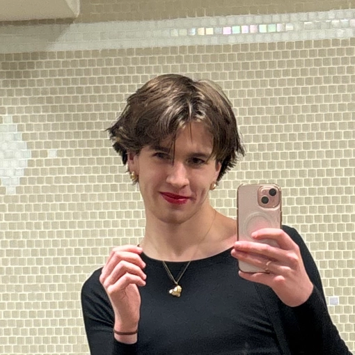 Student with short brown hair taking a selfie