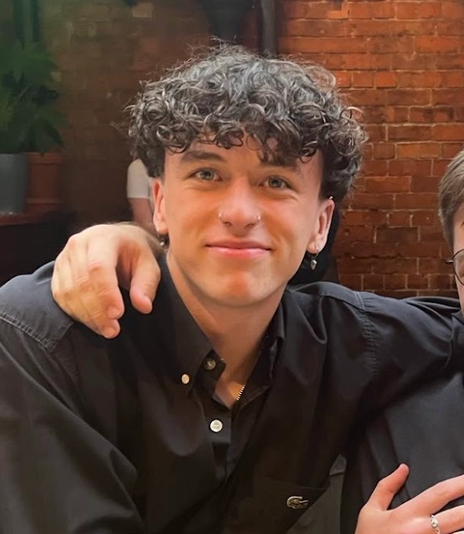 Student with curly short dark hair