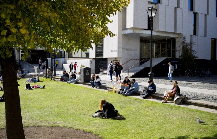 Students sitting outside the Longroom hub