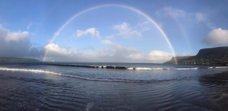 A rainbow over a lake