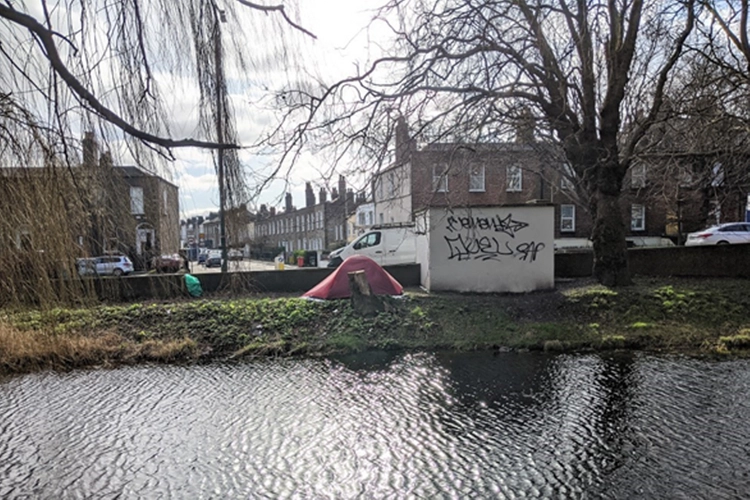 picture of a homeless tent on the canal