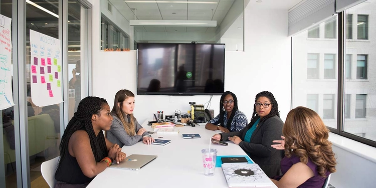 Boardroom meeting of four female professionals