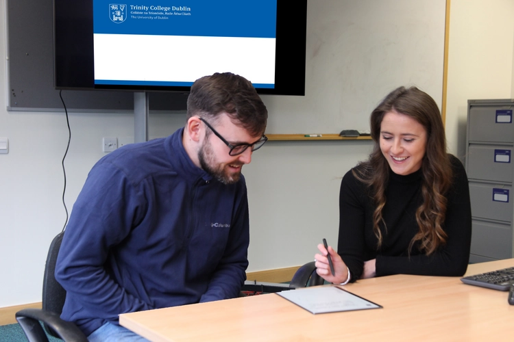 Two students sitting at a desk working together