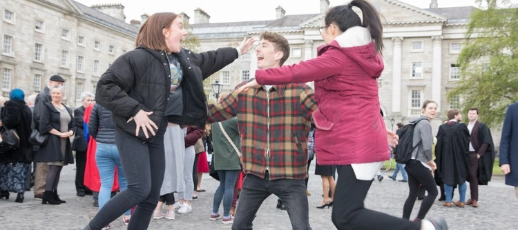 Three students celebrating