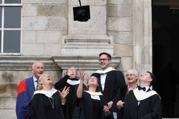 graduates throwing their cap in the air